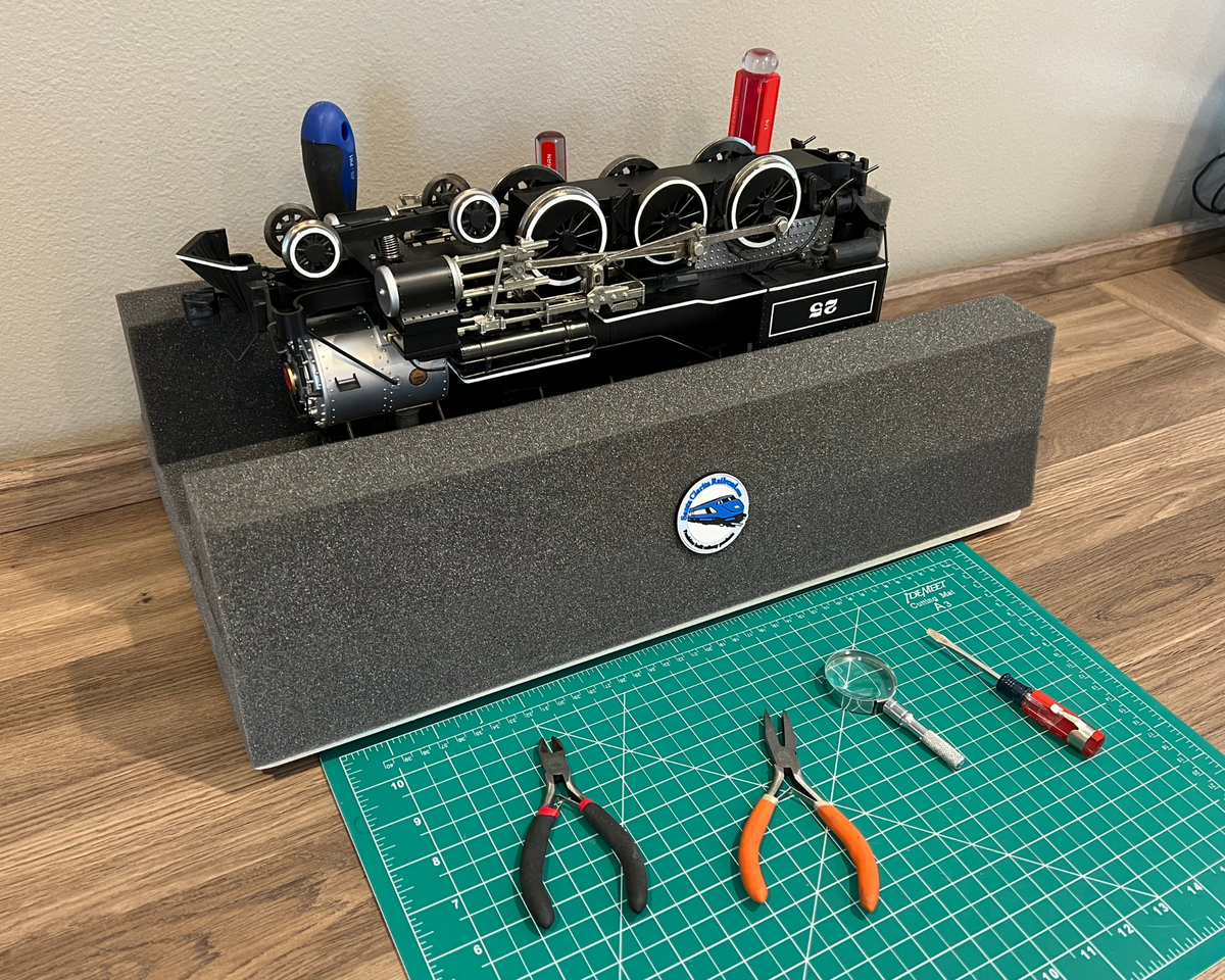 G scale model train engine on a handy holder with tools