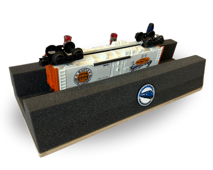 A gray polyurethane handy holder with stabilizing woodbase, featuring three convenient handy tool holes, and displaying toy trains on top.
