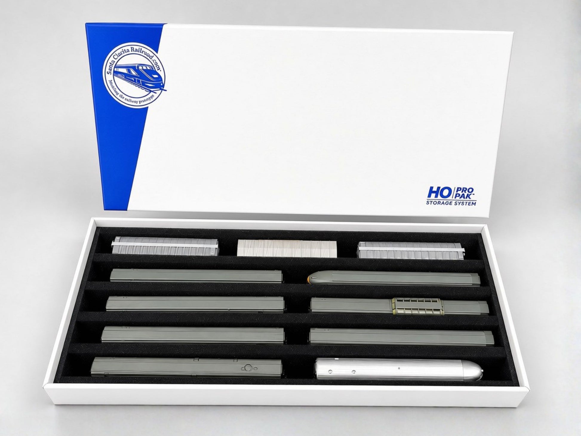 Pro Pak HO Standard box open with its lid behind, five channels of HO rolling stock stored upright